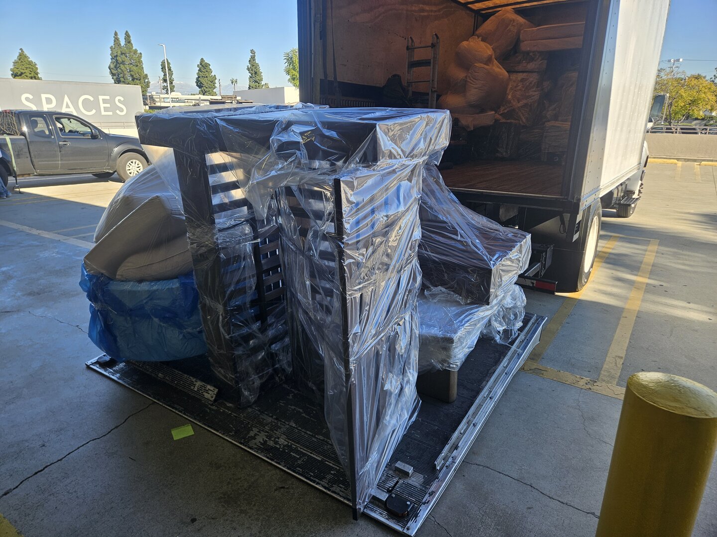 Commercial furniture delivery with hydraulic liftgate and professional protective wrapping