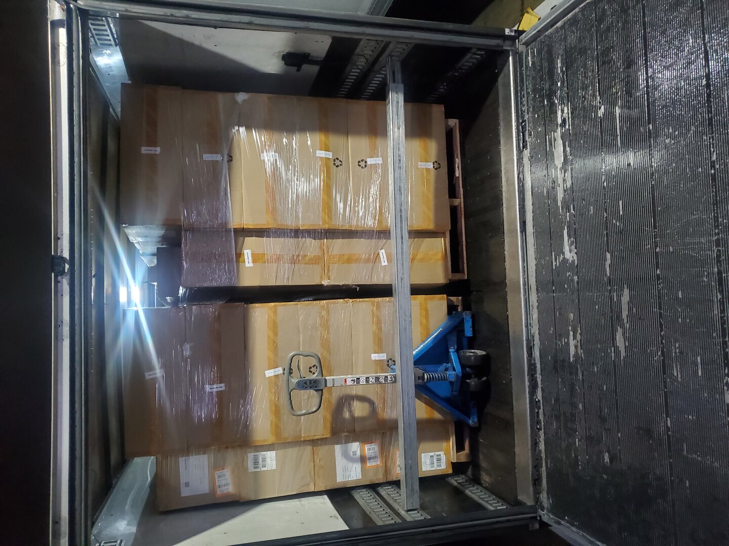 Large commercial warehouse move with pallet jacks and full truck load