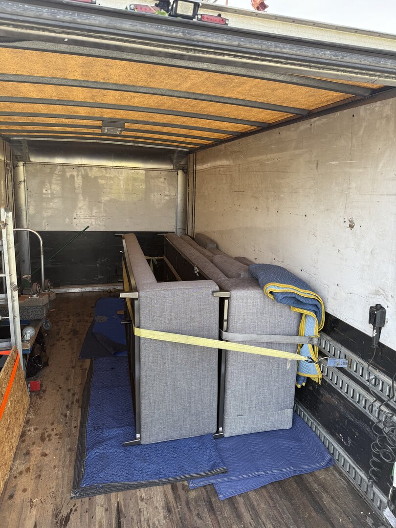 Professional furniture moving with secure strapping and protective padding